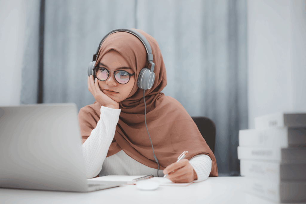A woman studying with a laptop, depicting a home-based, personalized learning